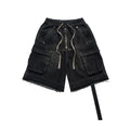 Black cargo shorts with multiple pockets and a drawstring on a white background