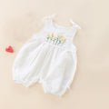 White baby romper with floral embroidery on a beige background, Obroi