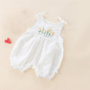 White baby romper with floral embroidery on a beige background, Obroi