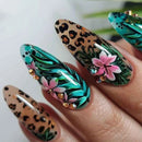 Nails with leopard print, floral, and green abstract designs on a white background, Obroi