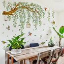 Dining room with a wooden table, chairs, and wall decals of birds and trees, Obroi
