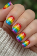 Close-up of hands with rainbow nail polish on a textured fabric background, Obroi