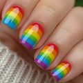 Close-up of hands with rainbow nail polish on a textured fabric background, Obroi