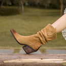 Tan suede boot with a block heel on a blurred natural background, Obroi