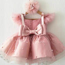 Pink children's dress with a large bow on a white background, Obroi
