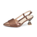Bronze high-heeled shoe with decorative elements on a white background, Obroi