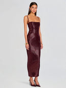 Woman wearing a burgundy snake print dress on a light gray background, Obroi