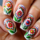 Nails with colorful floral and geometric designs on a white background, Obroi