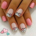 Nails with pink and white design featuring hearts and polka dots on a light background, Obroi