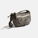Greenish-brown bag with lace detail on a white background, Obroi