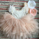 Children's dress with floral details on a textured fabric background, Obroi