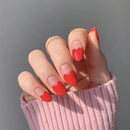 Hand with red heart-shaped nail art on a gray background, Obroi