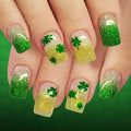 Nails with green glitter and shamrock designs on a green background, Obroi