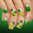 Nails with green glitter and shamrock designs on a green background, Obroi