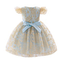 A baby girl's off-the-shoulder ball gown dress featuring a light blue and gold floral jacquard pattern, with a light blue satin bow at the waist and ruffled sleeves, shown against a plain white background, Obroi