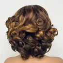 Curly brown hair styled in an updo against a white background, Obroi