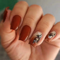 Hand with brown nail polish and floral design on a neutral background, Obroi
