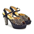Navy high-heeled sandals with gold embellishments on a white background, Obroi