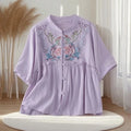 Lavender blouse with floral embroidery on a white stand against a neutral background, Obroi