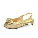 Gold glittery sandal with decorative bow on a white background, Obroi