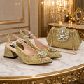 A pair of gold embellished slingback pumps with jeweled embellishments on the toes, displayed next to a matching gold embellished clutch bag on a marble and gold table in an elegant room, Obroi