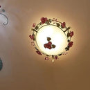 Ceiling light fixture with floral design on a beige wall, Obroi