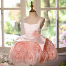 White and pink floral dress on a mannequin in front of a window with greenery, Obroi