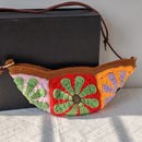 Colorful crocheted bag with geometric pattern on a white surface, Obroi