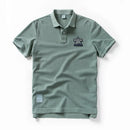 Green polo shirt with a logo on a white background, Obroi