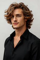 Man with styled hair wearing a black shirt against a plain background, Obroi