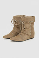 Pair of tan suede ankle boots with decorative lacing on a light gray background, Obroi