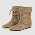Pair of tan suede ankle boots with decorative lacing on a light gray background, Obroi