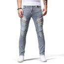 Person wearing light blue jeans with patches on a white background, Obroi