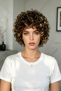 Woman with curly hair and mannequin heads with wigs on a white background, Obroi