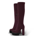 Pair of maroon knee-high boots with chunky platform heels on a white background, Obroi