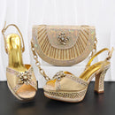 Gold high-heeled shoes and matching handbag with decorative elements on a black surface, Obroi