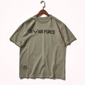 Khaki t-shirt with 'US Air Force' text on a hanger against a white background, Obroi