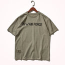 Khaki t-shirt with 'US Air Force' text on a hanger against a white background, Obroi