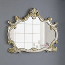 Decorative mirror with intricate gold frame on a gray walll, Obroi