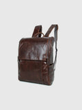 Brown leather backpack on a light gray background with 'Obroi' branding.