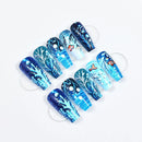 Set of blue and white nail art designs on clear sticks against a white background, Obroi