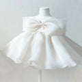 White dress with a large bow on a mannequin against a light gray background, Obroi