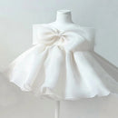 White dress with a large bow on a mannequin against a light gray background, Obroi