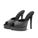 Black high-heeled shoes with rhinestone embellishments on a white background, Obroi