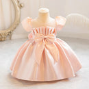 Pink dress on a mannequin with a decorative bow against a neutral background, Obroi
