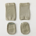 Set of four green baby booties with textured soles on a light gray background, Obroi