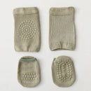 Set of four green baby booties with textured soles on a light gray background, Obroi