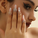 Close-up of a hand with decorative rings on a neutral background, Obroi