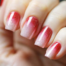 Close-up of a hand with red glittery nail polish on a blurred background, Obroi
