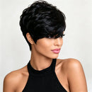 A woman with a short, layered, textured black wig shown from the chest up against a light gray studio background. She is wearing a black halter top, Obroi